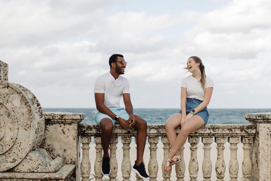 Two PBA students talk by the beach.